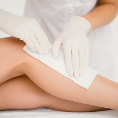 therapist-waxing-womans-leg-spa-center