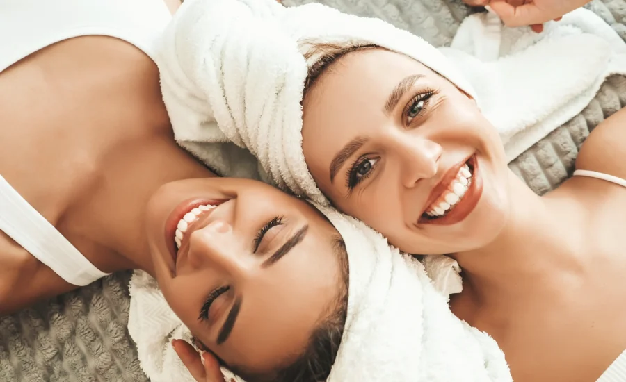 two-young-beautiful-smiling-women-white-bathrobes-towels-head